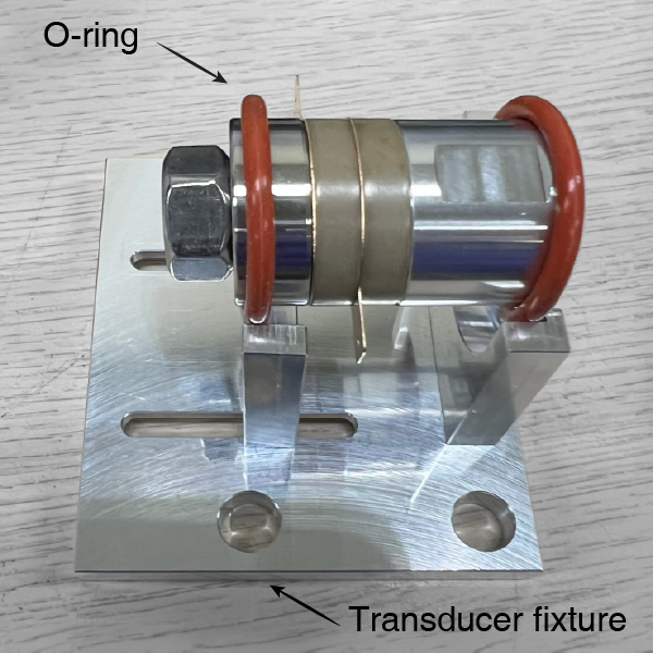 Langevin-type configuration mounted on transducer fixture with O-ring